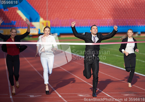 Image of business people running on racing track