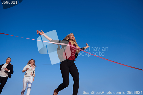 Image of business people running on racing track