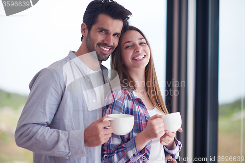 Image of relaxet young couple drink first morning coffee