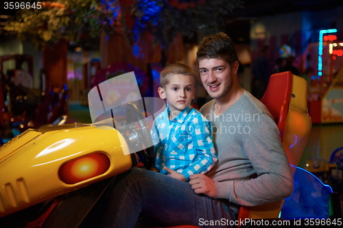 Image of father and son playing game in playground