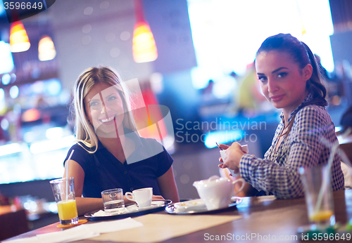 Image of girls have cup of coffee in restaurant