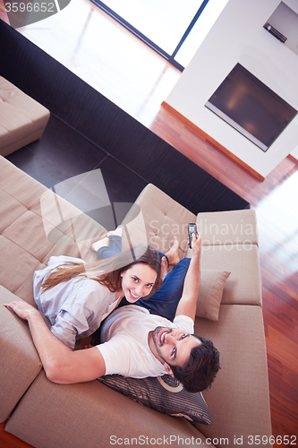 Image of young couple watching tv at home