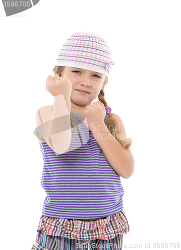 Image of Little Girl in Bright Dress Shows Fists