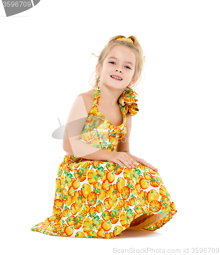 Image of Little Girl in a Yellow Dress Posing