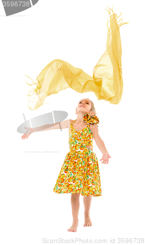 Image of Little Girl in a Yellow Dress throws up Shawl