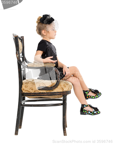 Image of Little Girl Sitting in Antique Chair