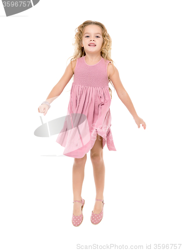 Image of Little Girl in a Pink Dress Jumping