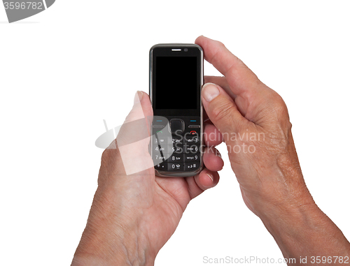 Image of Hands of senior womanwith a mobile phone