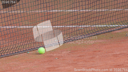 Image of Gravel tennis court with tennis ball