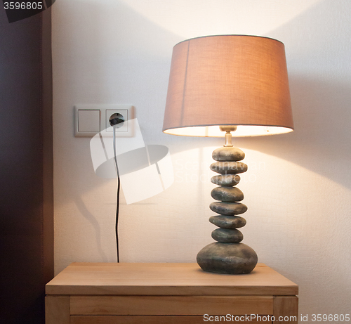 Image of Modern table lamp on a bedside table