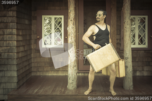 Image of Gentleman Dressed in 1920’s Era Swimsuit Holding Suitcases on 