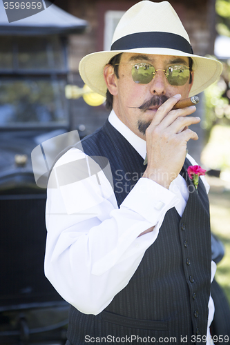 Image of 1920s Dressed Man Near Vintage Car Smoking Cigar