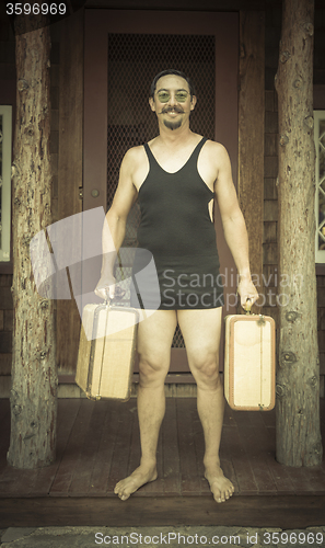 Image of Gentleman Dressed in 1920’s Era Swimsuit Holding Suitcases on 