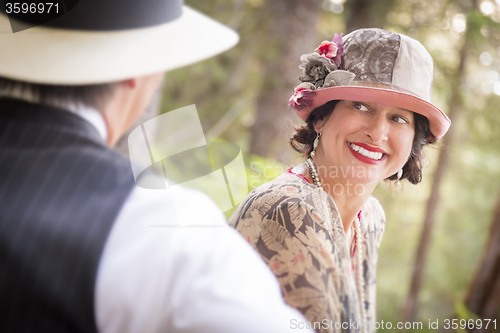 Image of 1920s Dressed Romantic Couple Flirting Outdoors