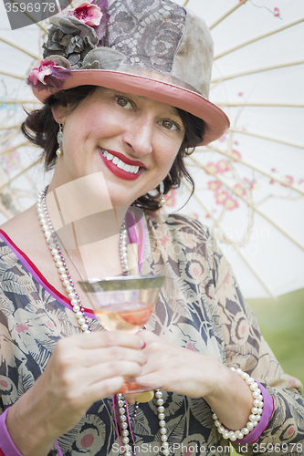 Image of 1920s Dressed Girl with Parasol and Glass of Wine Portrait