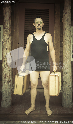 Image of Gentleman Dressed in 1920’s Era Swimsuit Holding Suitcases on 