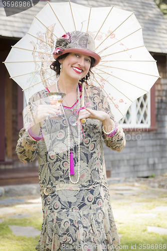 Image of 1920s Dressed Girl with Parasol and Glass of Wine Portrait