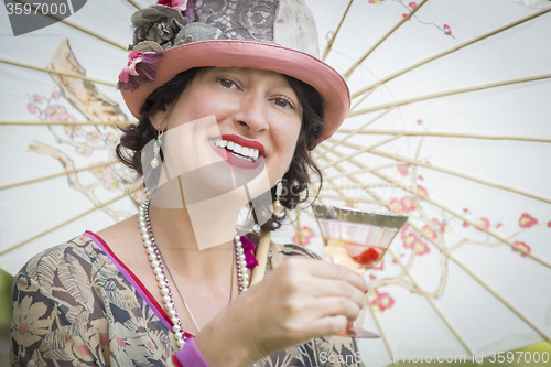 Image of 1920s Dressed Girl with Parasol and Glass of Wine Portrait