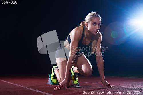 Image of pixelated design of woman  sprinter leaving starting blocks