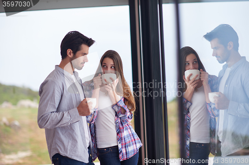 Image of relaxet young couple drink first morning coffee