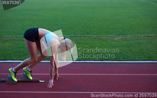 Image of pixelated design of woman  sprinter leaving starting blocks