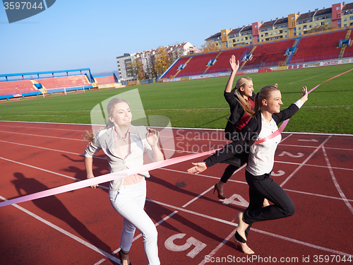 Image of business people running on racing track