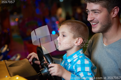 Image of father and son playing game in playground