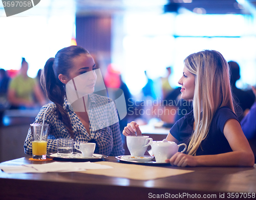 Image of girls have cup of coffee in restaurant