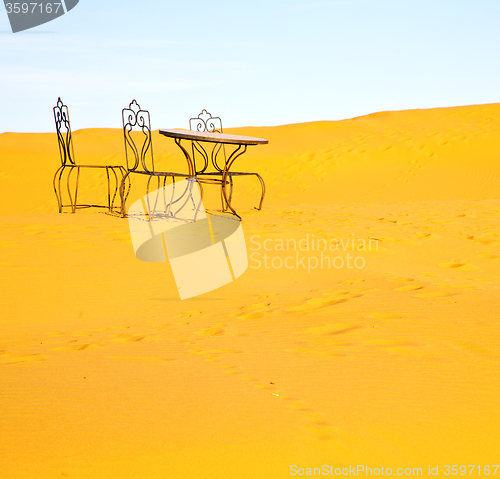 Image of table and seat in desert sahara morocco africa yellow sand
