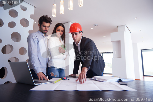 Image of couple buying new home with real estate agent