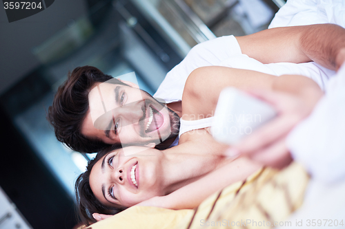 Image of couple relax and have fun in bed