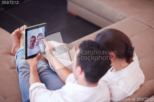 Image of couple at modern home using tablet computer