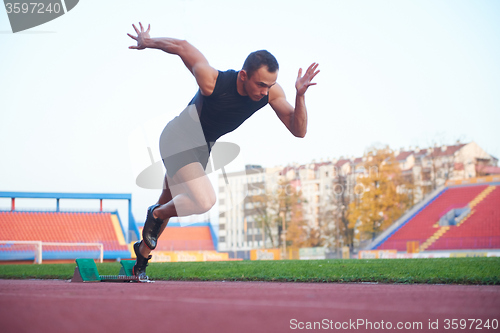 Image of pixelated design of woman  sprinter leaving starting blocks