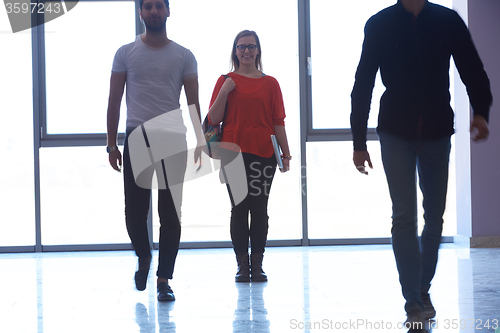 Image of student girl standing with laptop, people group passing by