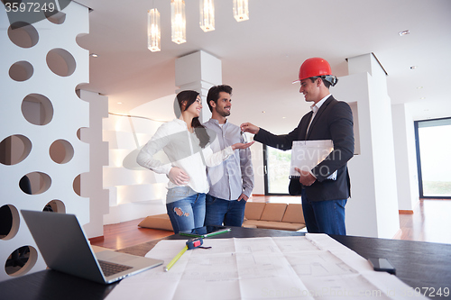 Image of couple buying new home with real estate agent