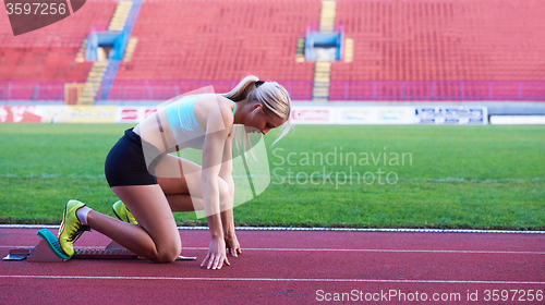 Image of pixelated design of woman  sprinter leaving starting blocks