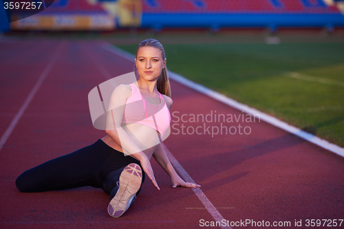 Image of sporty woman on athletic race track