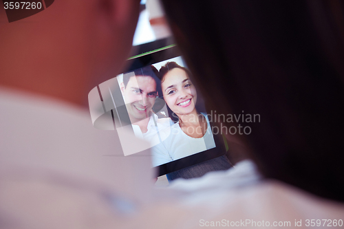 Image of couple at modern home using tablet computer