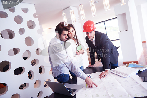 Image of couple buying new home with real estate agent