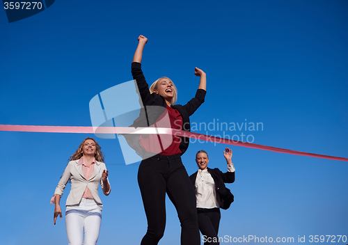 Image of business people running on racing track