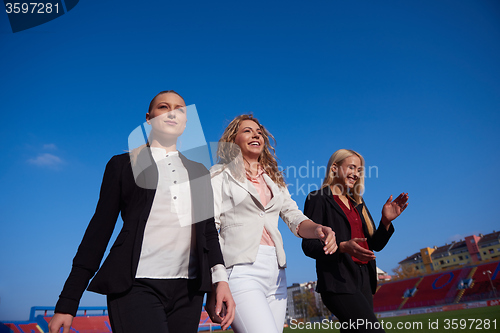 Image of business people running on racing track