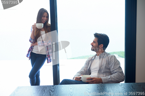 Image of relaxet young couple drink first morning coffee