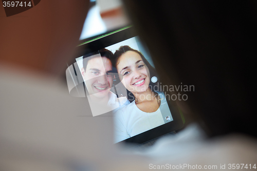 Image of couple at modern home using tablet computer