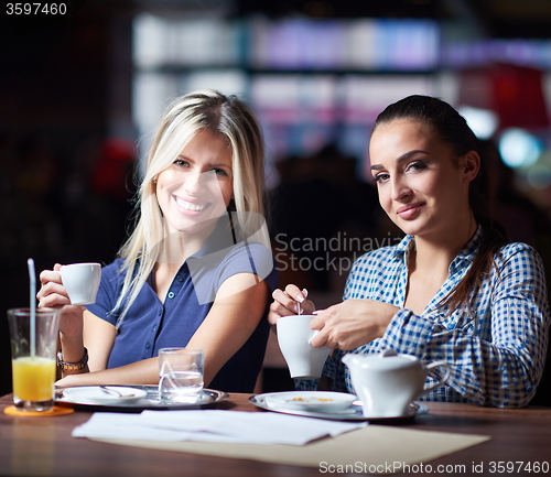Image of girls have cup of coffee in restaurant