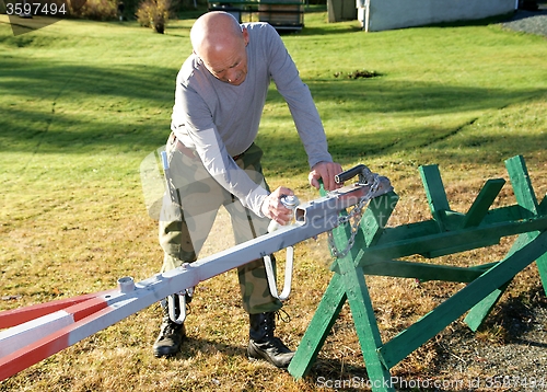 Image of Man painting a tow bar