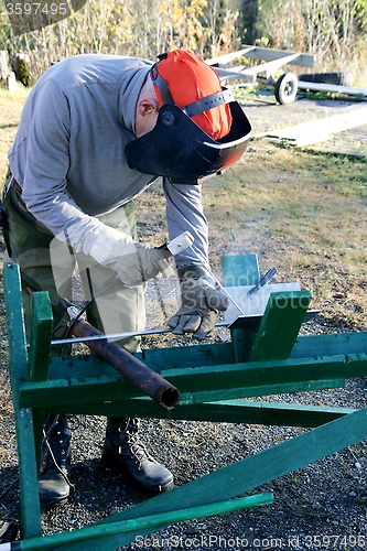 Image of Worker welding steel