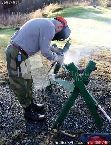 Image of Worker welding steel