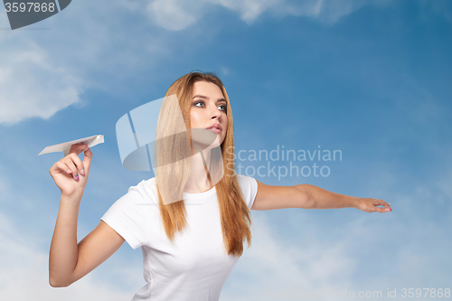 Image of Woman holding a paper airplane