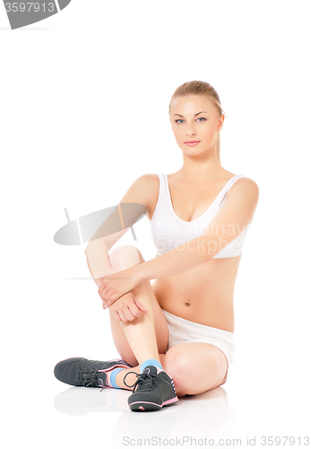 Image of Woman doing fitness exercise on floor