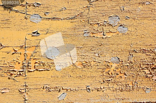 Image of grungy yellow paint on wood